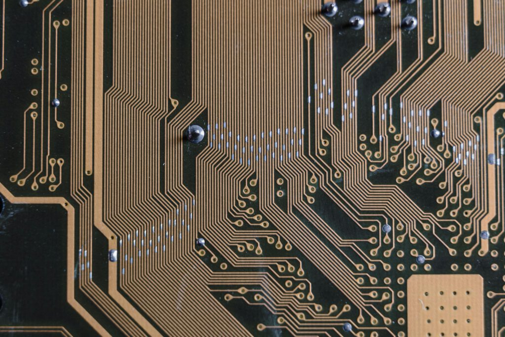 pexels-photo-6755065-6755065 Detailed view of a circuit board with intricate gold traces.